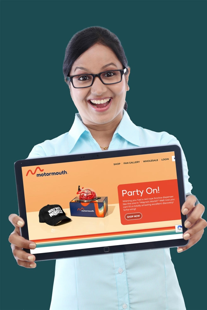 Woman holding up tablet displaying Motormouth Innovations website