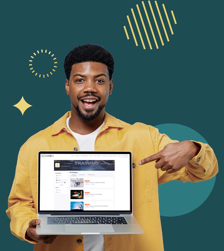 Man pointing excitedly to laptop displaying Cedaron site